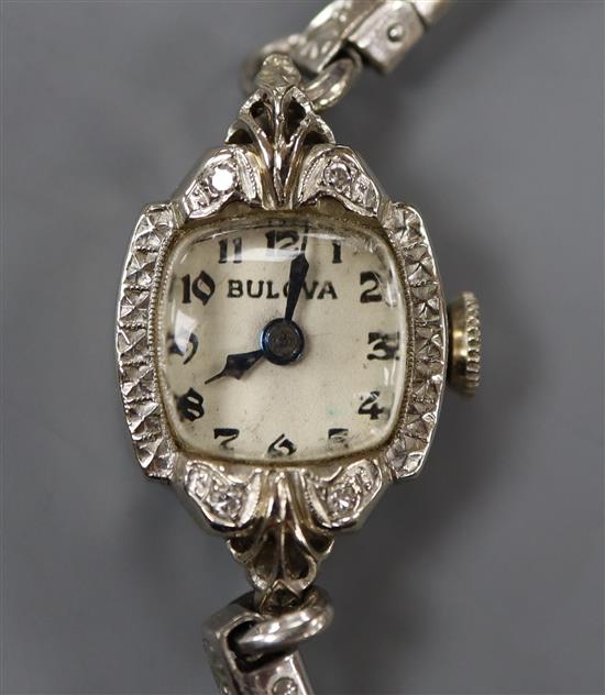 A ladys 14k white metal and diamond set Bulova manual wind cocktail watch.